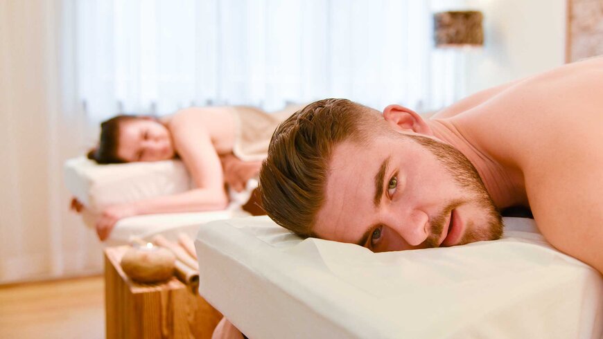 Ein Paar genießt eine entspannende Paarmassage in einem Wellnesszentrum.